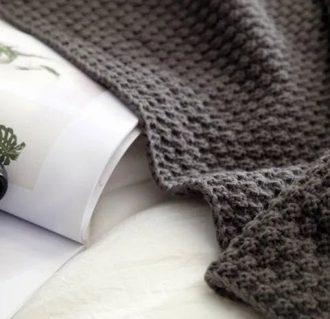 Acrylic knit ball blanket in beige colour, measuring 130 by 170 centimetres, laid flat.