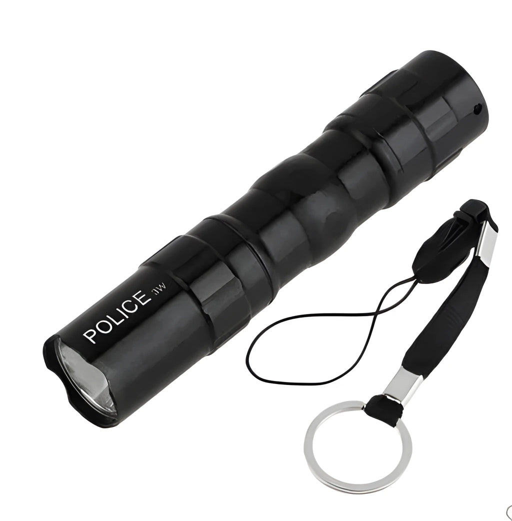 Black aluminium mini LED flashlight showing size next to a AA battery for scale.