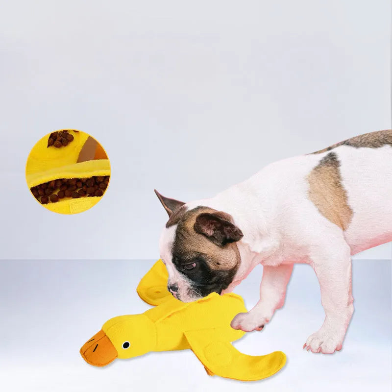 Yellow plush teddy duck dog training toy with squeaker and treat dispensing compartment.