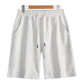 Men's straight-leg cotton sports shorts in light grey with an elastic waistband, laid flat.