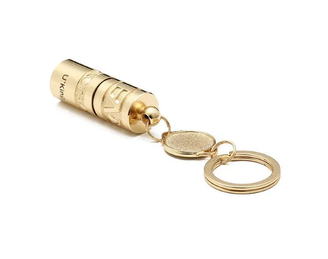 Gold-coloured waterproof mini LED flashlight on a keychain ring.