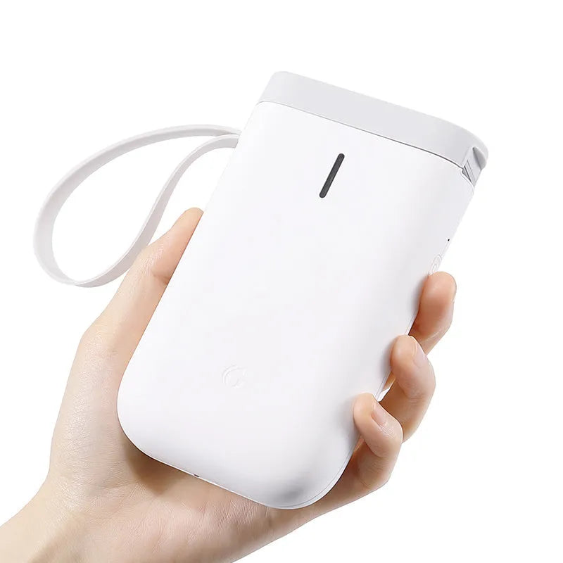 D11 compact black Bluetooth thermal label printer with LCD screen on a desk.