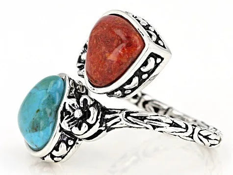 Antique silver electroplated alloy insect ring with turquoise stone on a white background