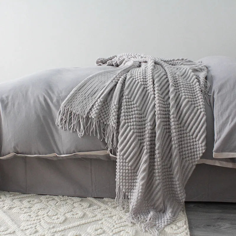Small polyester nap blanket in dark grey, khaki, or light grey measuring 127x170cm