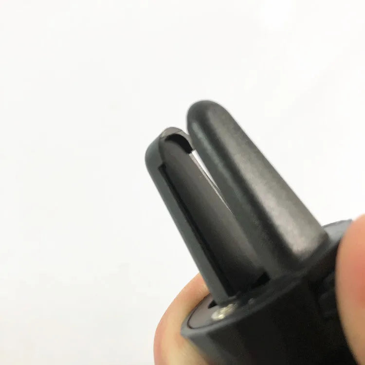 Black car phone holder clipped to a car air vent