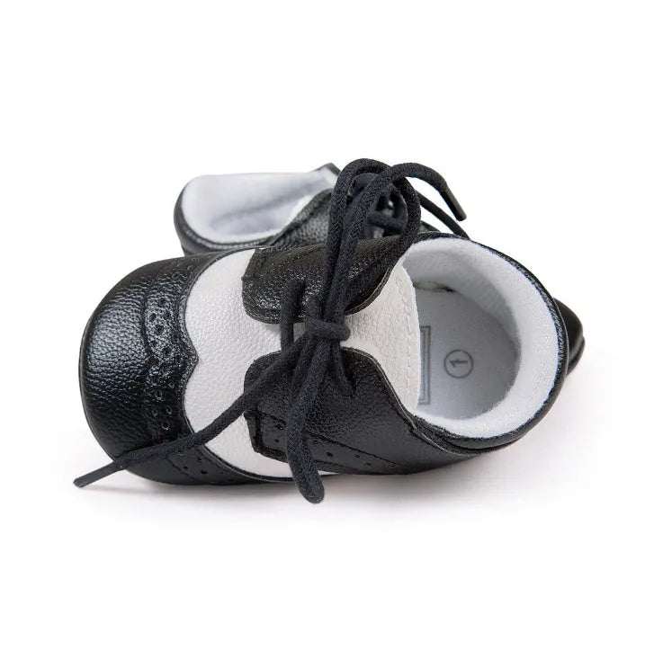 Vintage style baby shoes with soft soles in black synthetic leather
