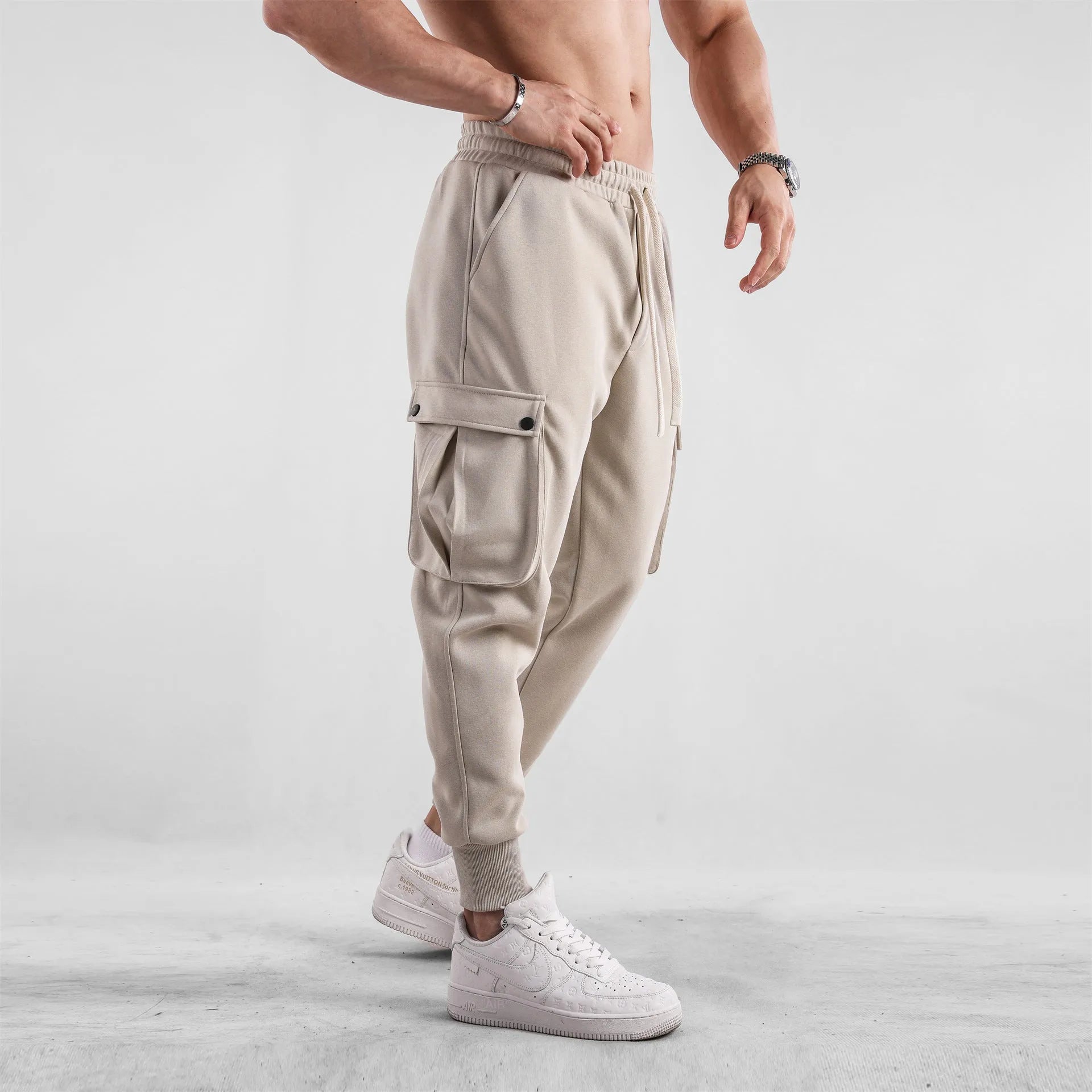 Men's loose cotton sports trousers with ankle tie detail and multiple pockets in apricot colour