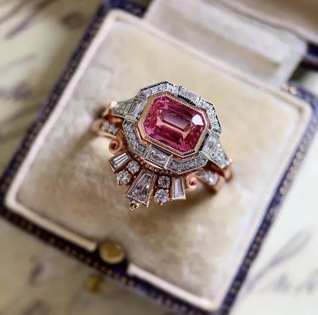 Rose gold-tone women's retro style ring with geometric ruby design on a hand.