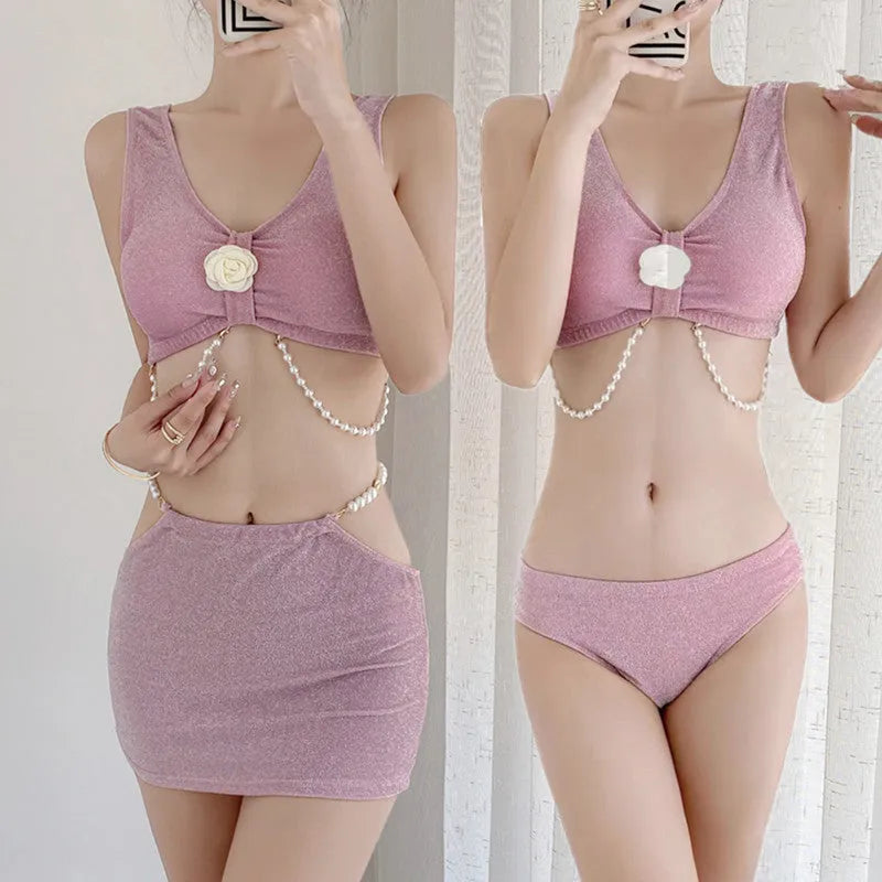 Pink and black women's three-piece bikini swimsuit on a white background.