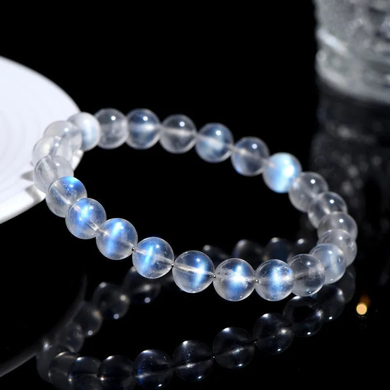 Natural cream body blue moonlight crystal bracelet on a plain background showing its size and style.