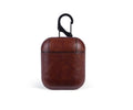 Genuine leather protective pouch for Apple AirPods charging case in black, brown, light brown, and red.