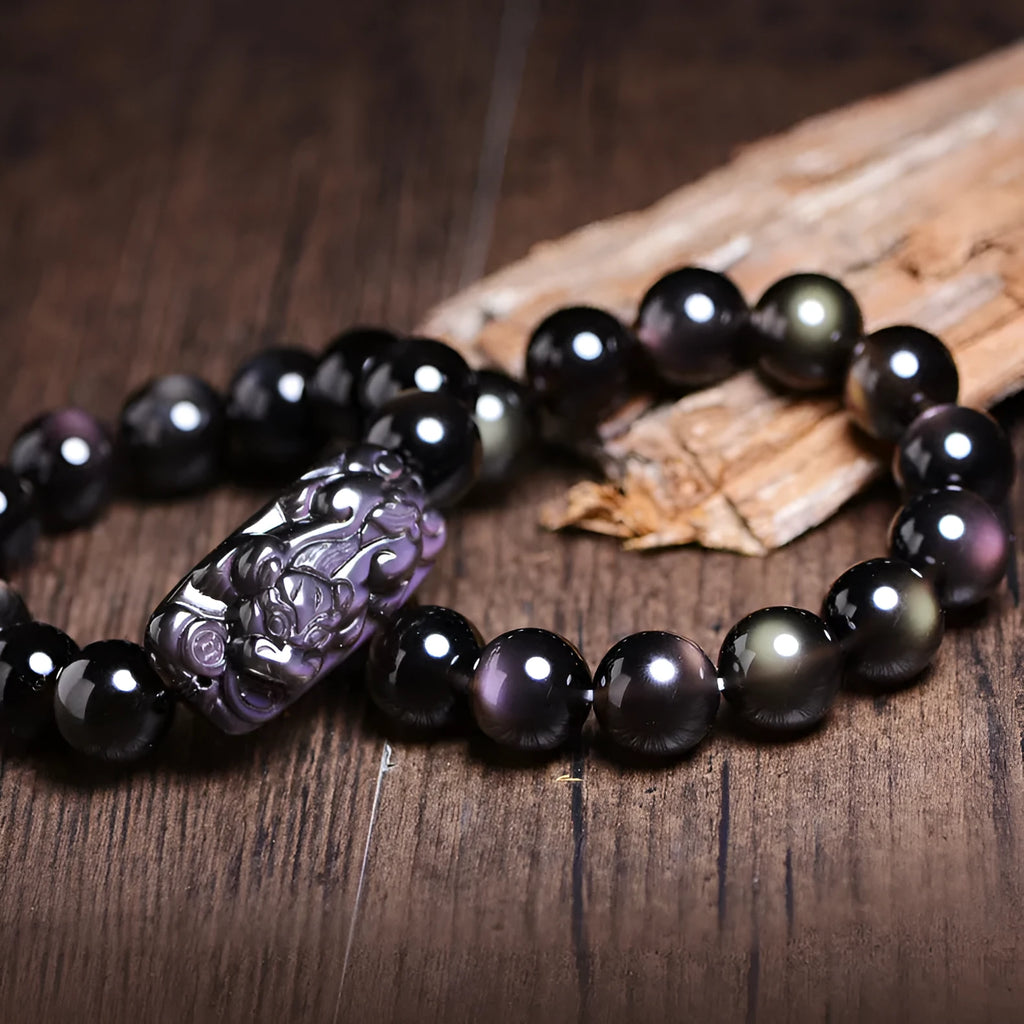 Polished natural crystal Pi Xiu bracelet with ethnic geometric design on a wrist