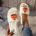 White and yellow pumpkin-themed plush open-toe slippers with a synthetic fur upper.