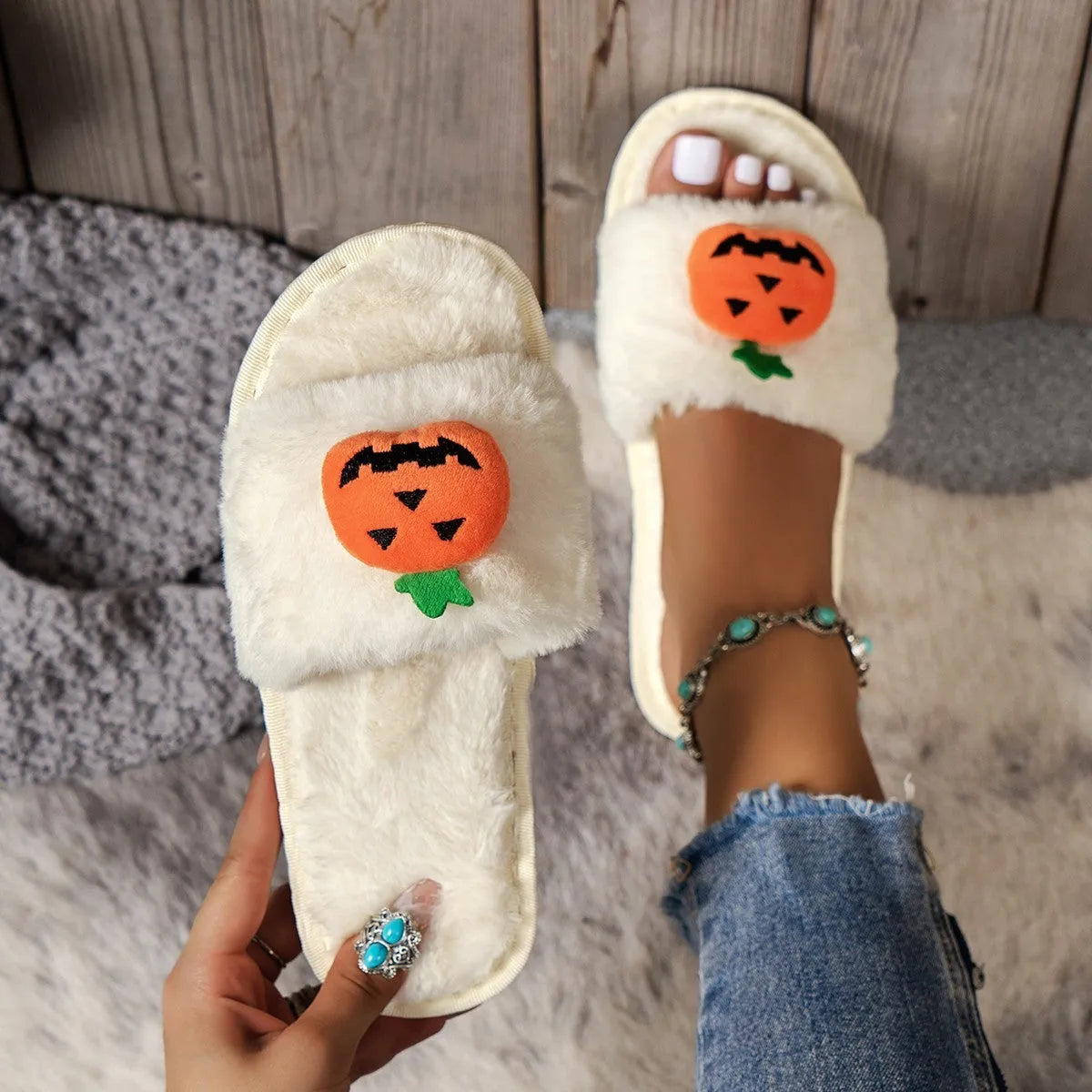 White and yellow pumpkin-themed plush open-toe slippers with a synthetic fur upper.