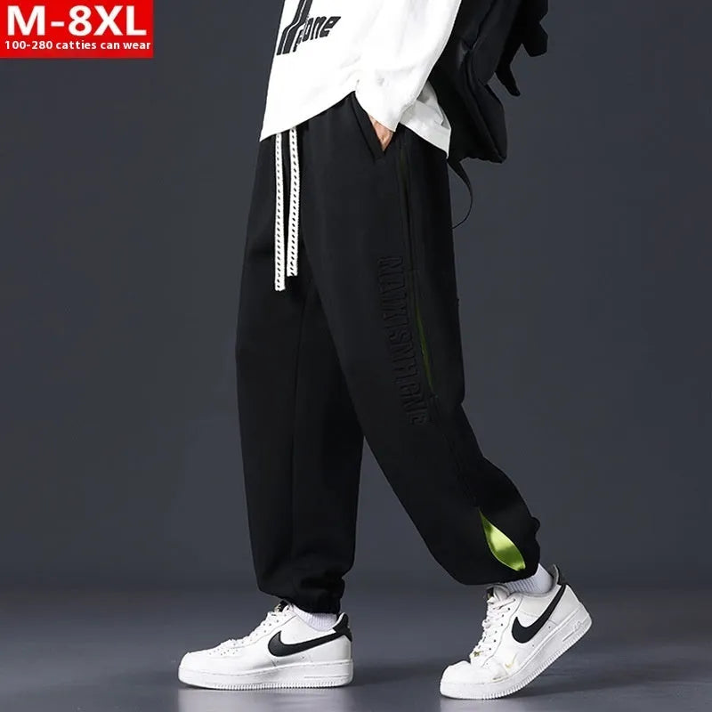 Men's loose-fit cotton trousers with printed stitching detail and ankle banding in grey green colour