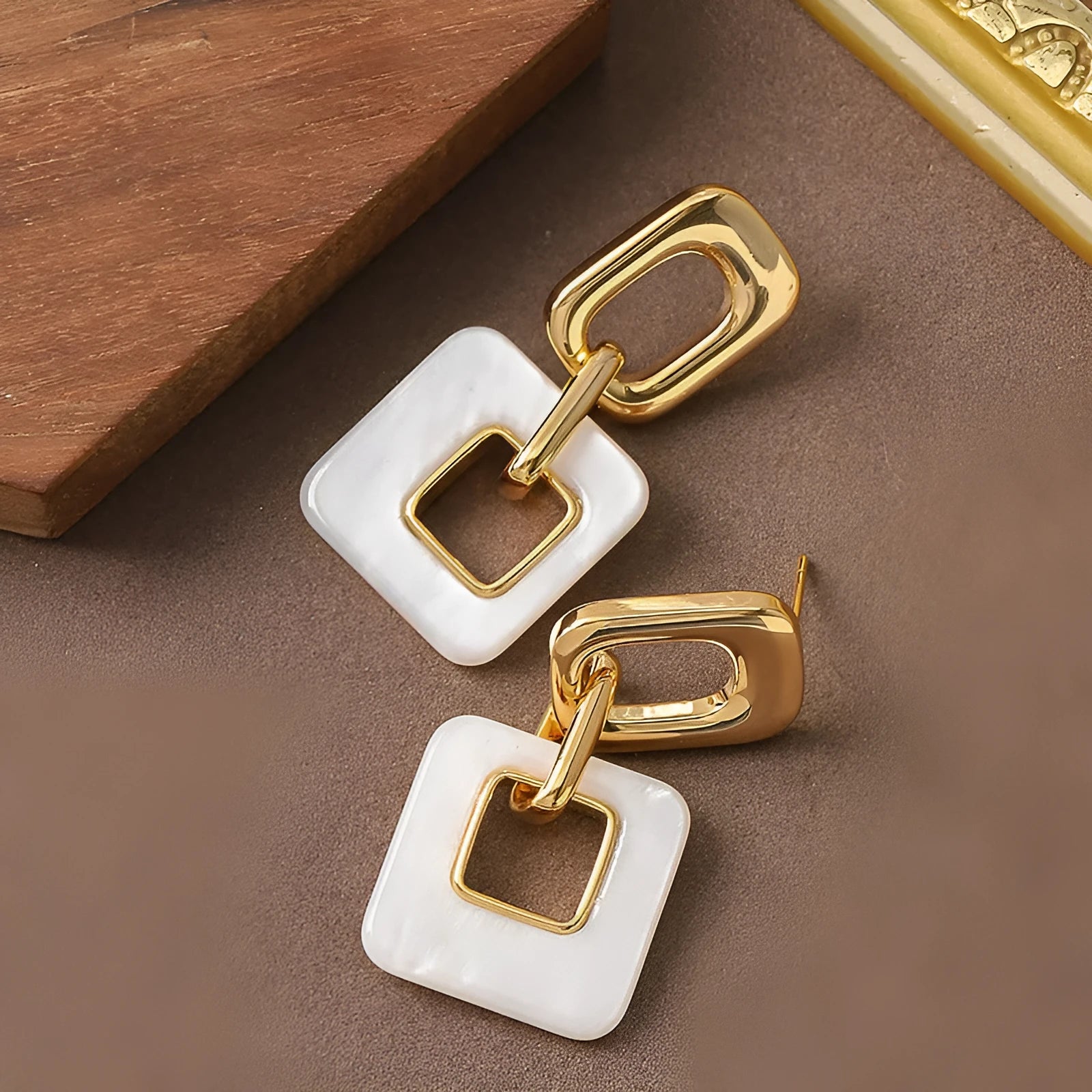 Copper hollow geometric square earrings with electroplated finish, chamfered corners, and two colour options