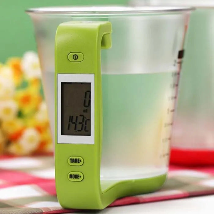 Digital kitchen scale measuring cup in green with LCD display on handle showing weight