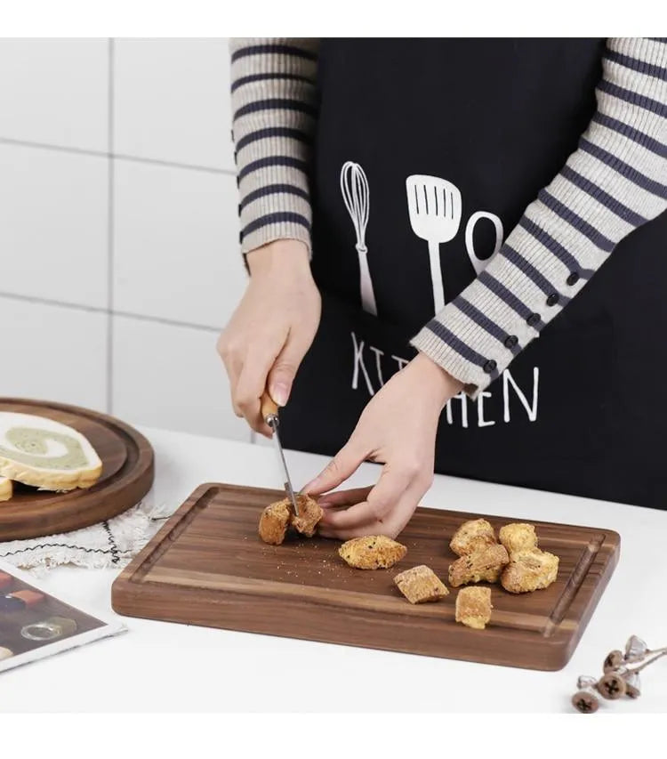 Black walnut wood cutting board with juice groove, dual-sided design, available in round and rectangular sizes for kitchen use