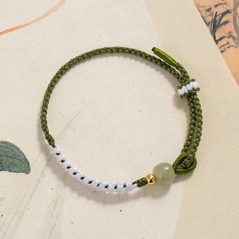 Women's Chinese national bracelet with Hetian jade, sterling silver, and colourful cord carrying strap