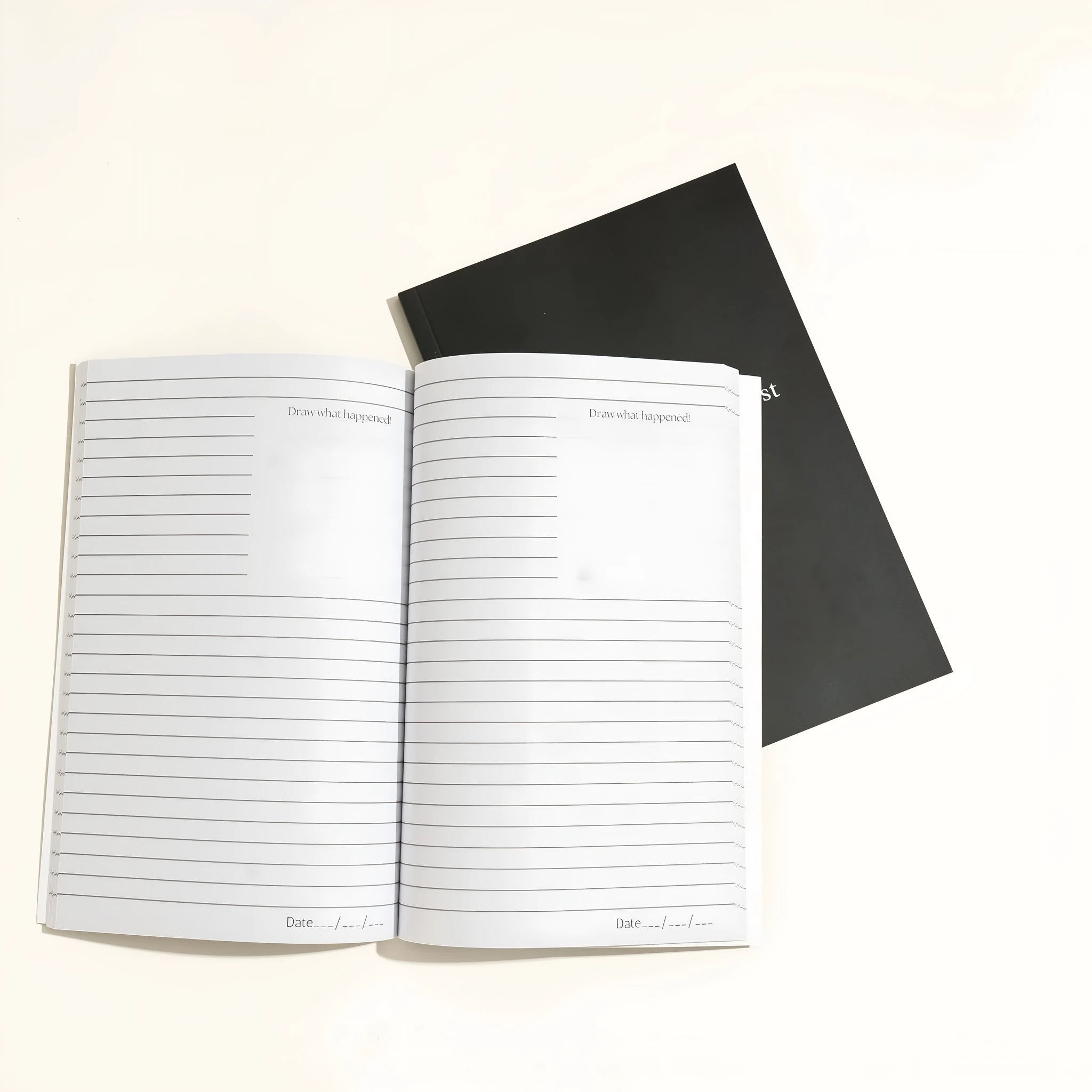 Black hardcover Dream Journal notebook for recording dreams and personal reflections.