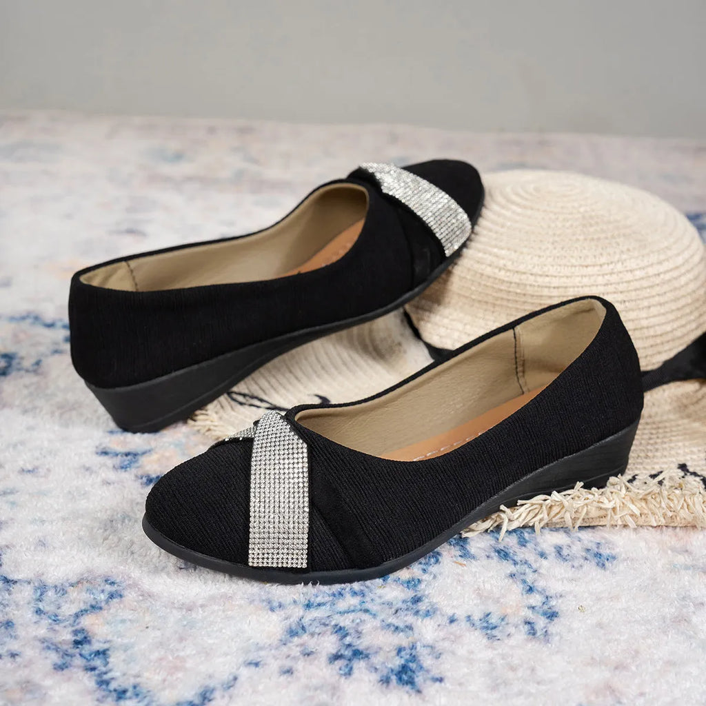 Black women's slip-on casual shoes with rhinestone details on the fabric upper and a chunky short heel.