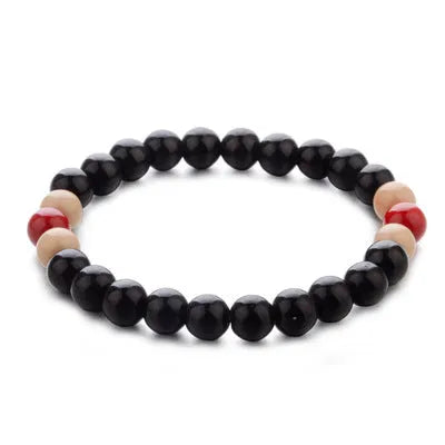 Natural stone bead bracelet with lava stones on a wrist, showing ethnic style and unisex design.