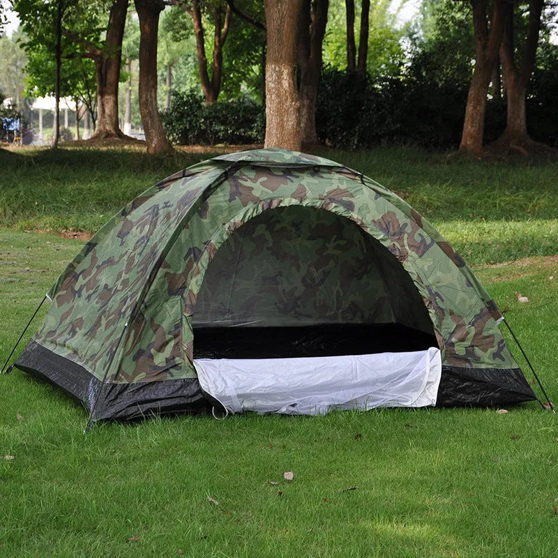 Green camouflage camping tent with triangular skylight, breathable mesh panels, and steel ground nails set up outdoors