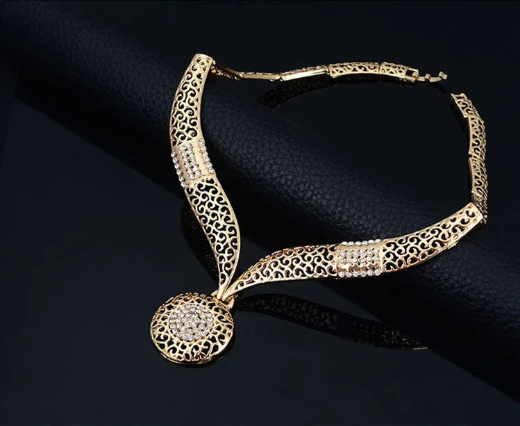 Gold jewellery four piece set with necklace, earrings, ring, and hand accessories featuring alloy and artificial gems
