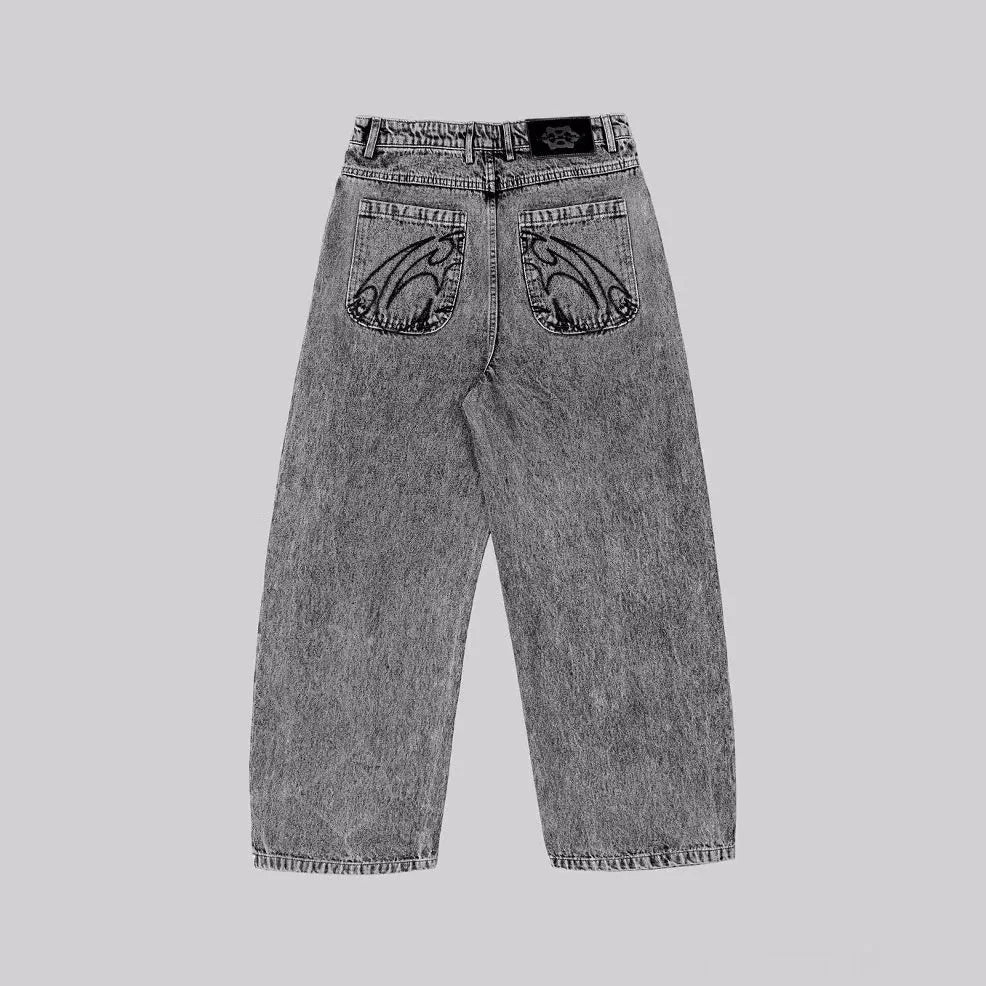 Grey loose fit straight leg denim trousers for men and women on a plain background