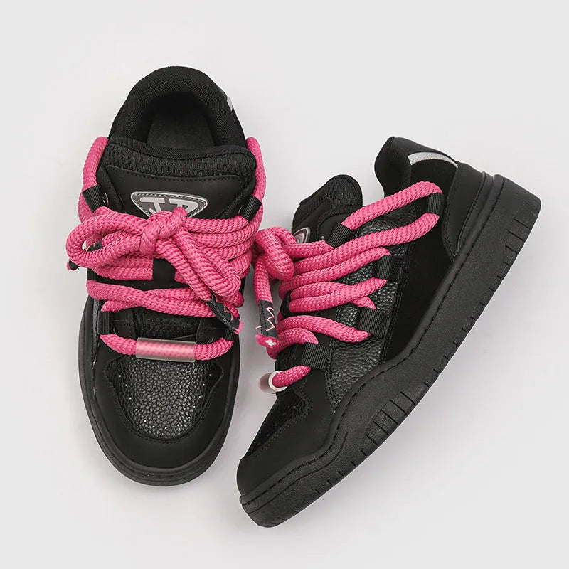 Pair of low-top unisex casual lace-up shoes with a thick rubber sole, shown in a solid colour.