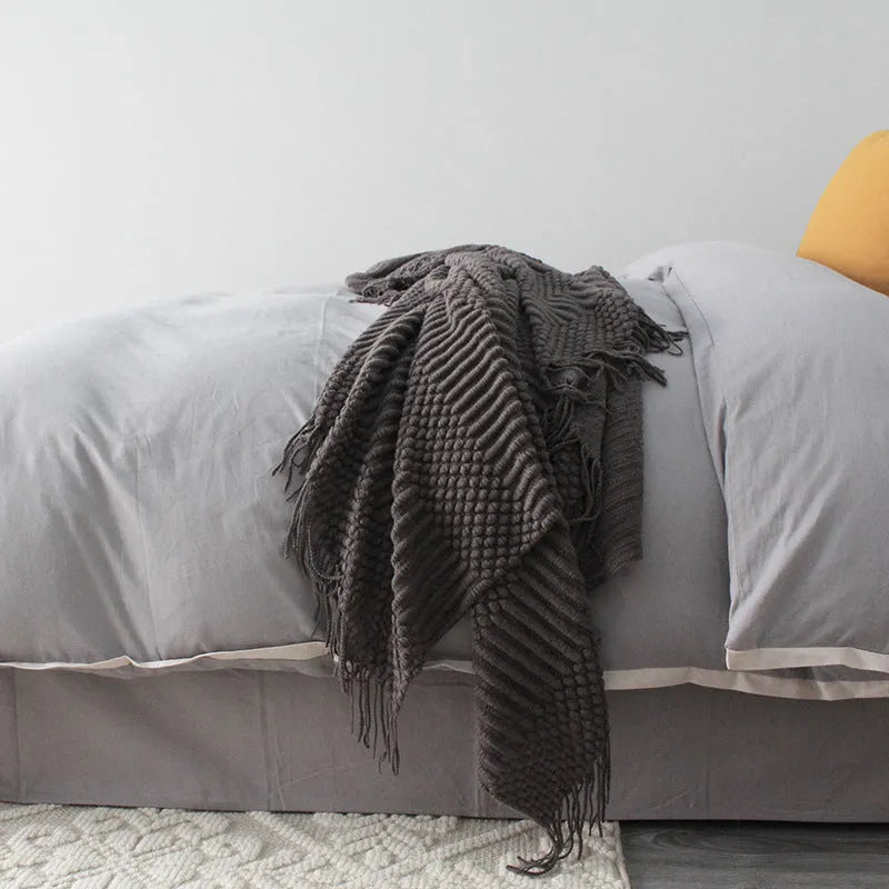 Small polyester nap blanket in dark grey, khaki, or light grey measuring 127x170cm