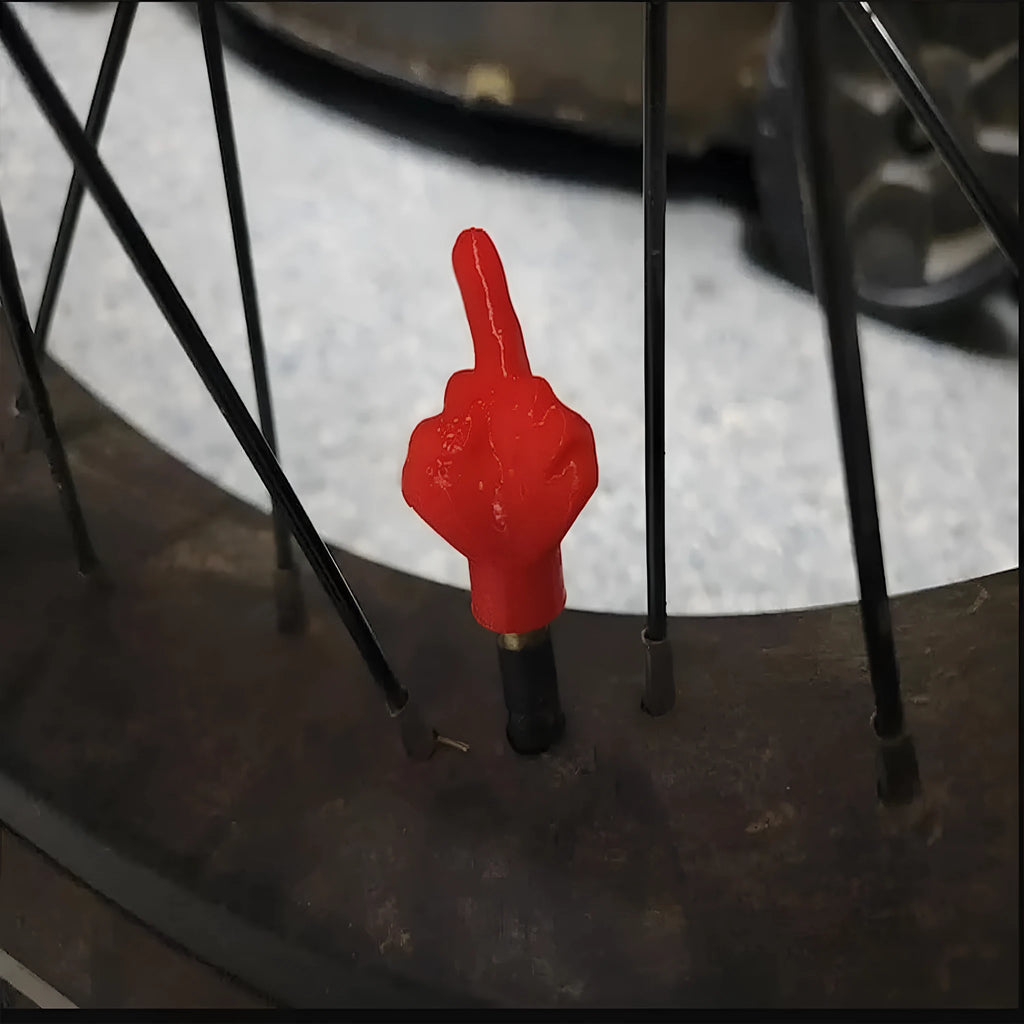 Eight car tyre valve caps, four black and four beige, made from latex rubber with standard threads