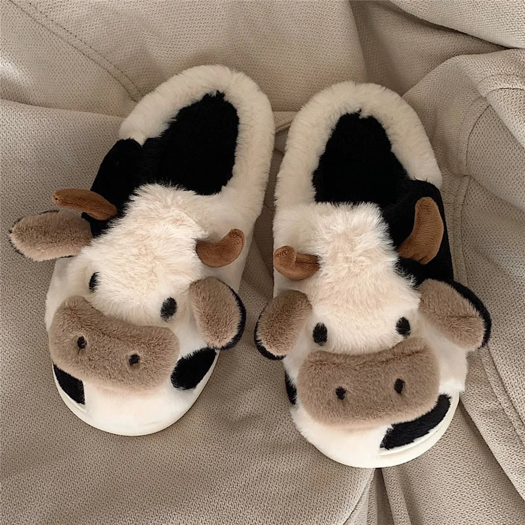 White cartoon cow slippers for women with fluffy faux fur and a textured non-slip sole.