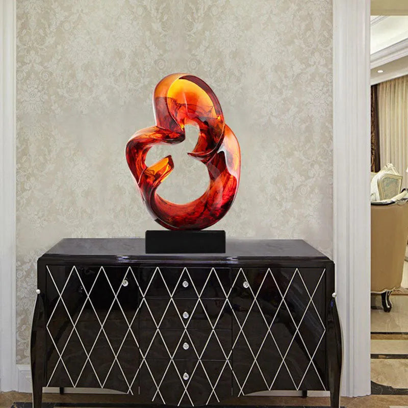 Transparent resin modern sculpture ornament in orange red colour on display surface