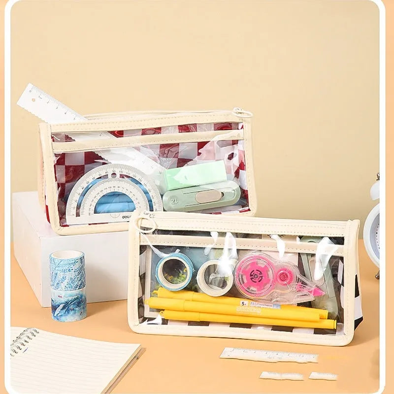 Transparent PVC pencil case with chessboard grid pattern showing pens inside, 21.5cm long