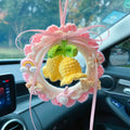 Handwoven wool bell orchid car pendant hanger in various colours on a car mirror.