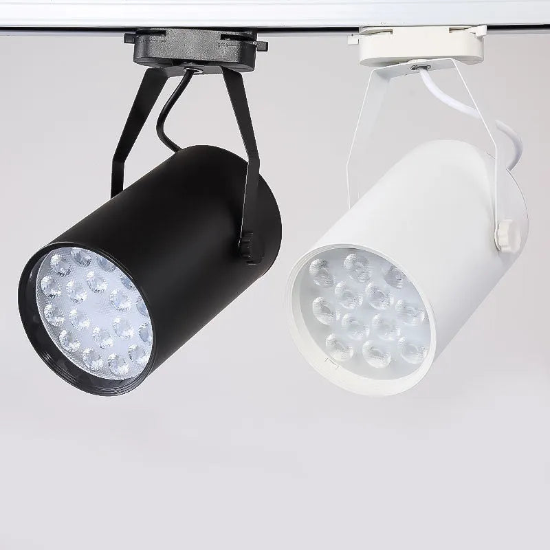 Black and white aluminium LED track spotlight on a lighting track for store display walls.