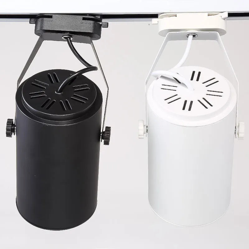 Black and white aluminium LED track spotlight on a lighting track for store display walls.