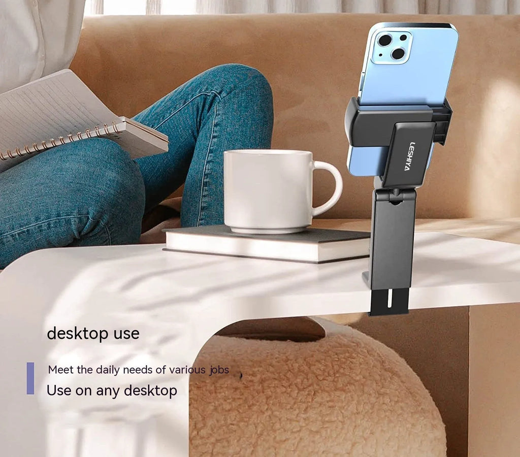 Foldable rotating universal phone holder in black, green, and grey colours on a desk.