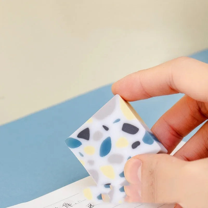 Brick-shaped solid rubber traceless eraser for pencil correction.