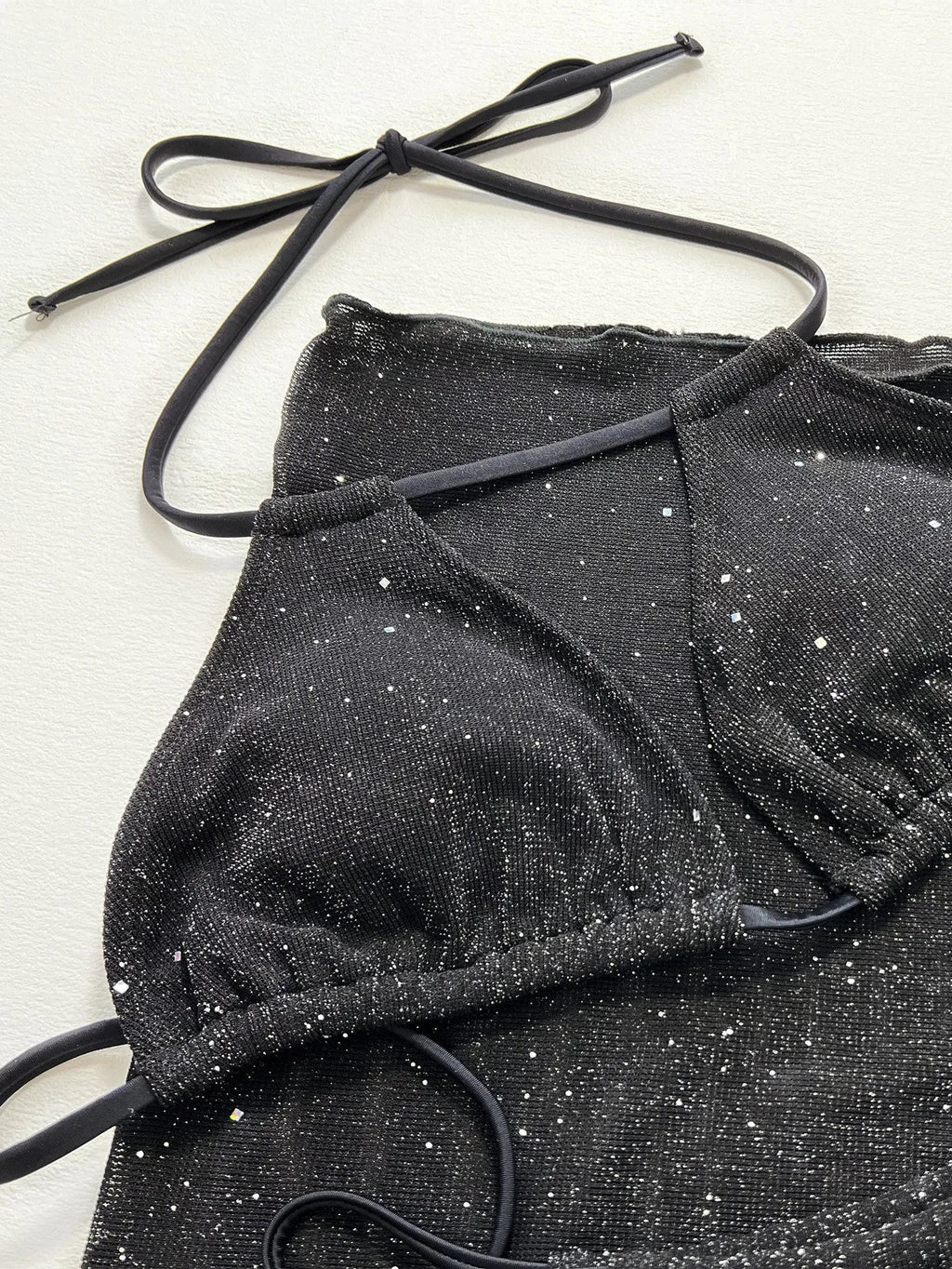 Black three-piece bikini swimsuit set with separate top and shorts