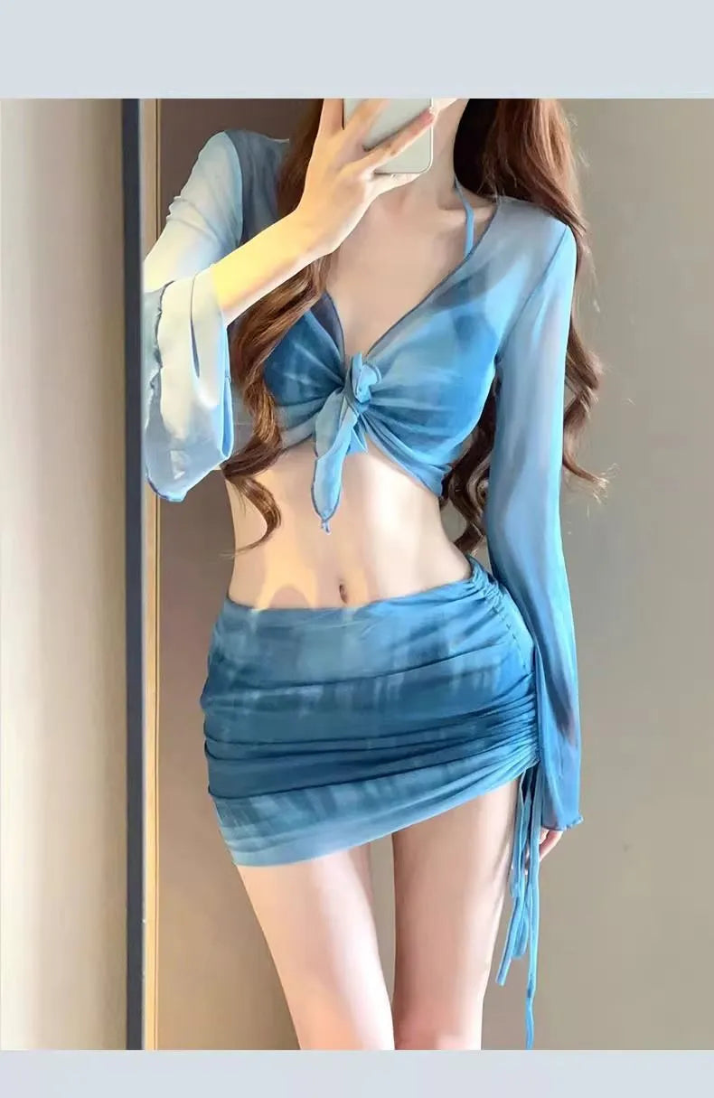 Women's blue four-piece bikini swimsuit set showing shirt, bra, high-waist brief, and skirt for swimming and fitness