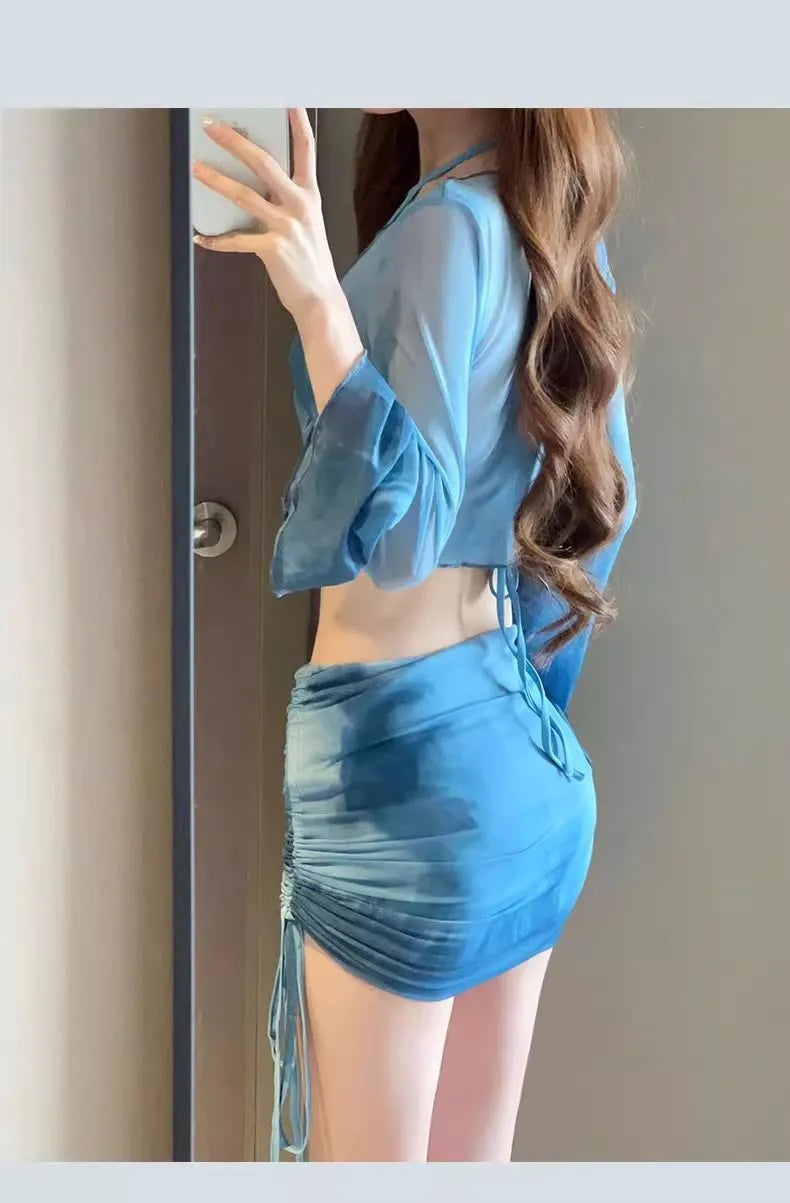 Women's blue four-piece bikini swimsuit set showing shirt, bra, high-waist brief, and skirt for swimming and fitness