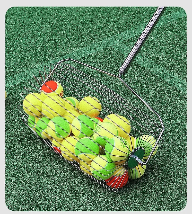 Stainless steel tennis ball picker roller on a court next to tennis balls.