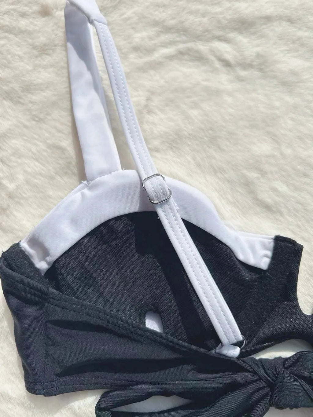 Low waist black women's bikini bottoms with stitching split, nylon spandex, front view