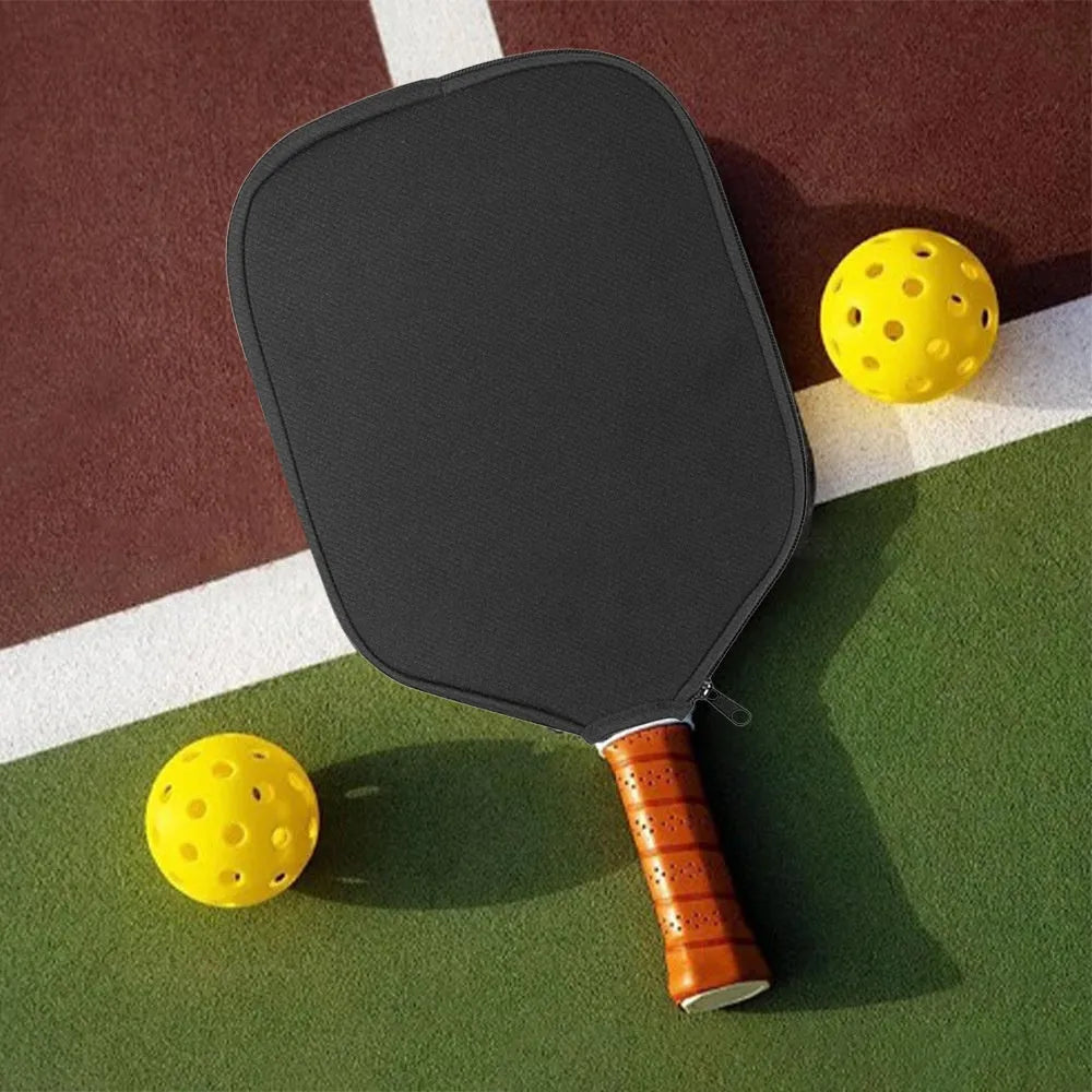 Black neoprene protective sleeve for table tennis racket, laid flat on surface