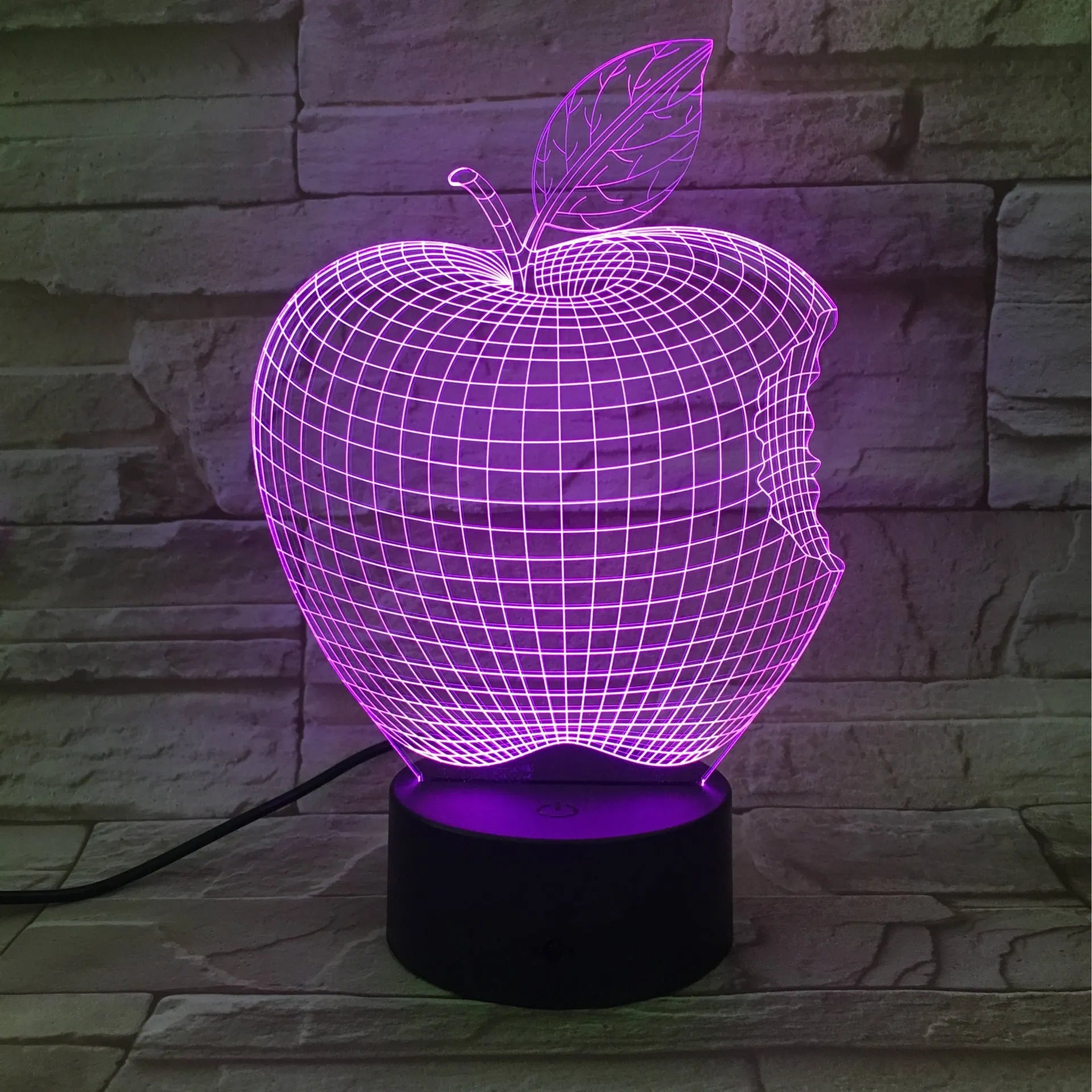 3D fruit-shaped night light with colourful LED glow and touch controls on a table.