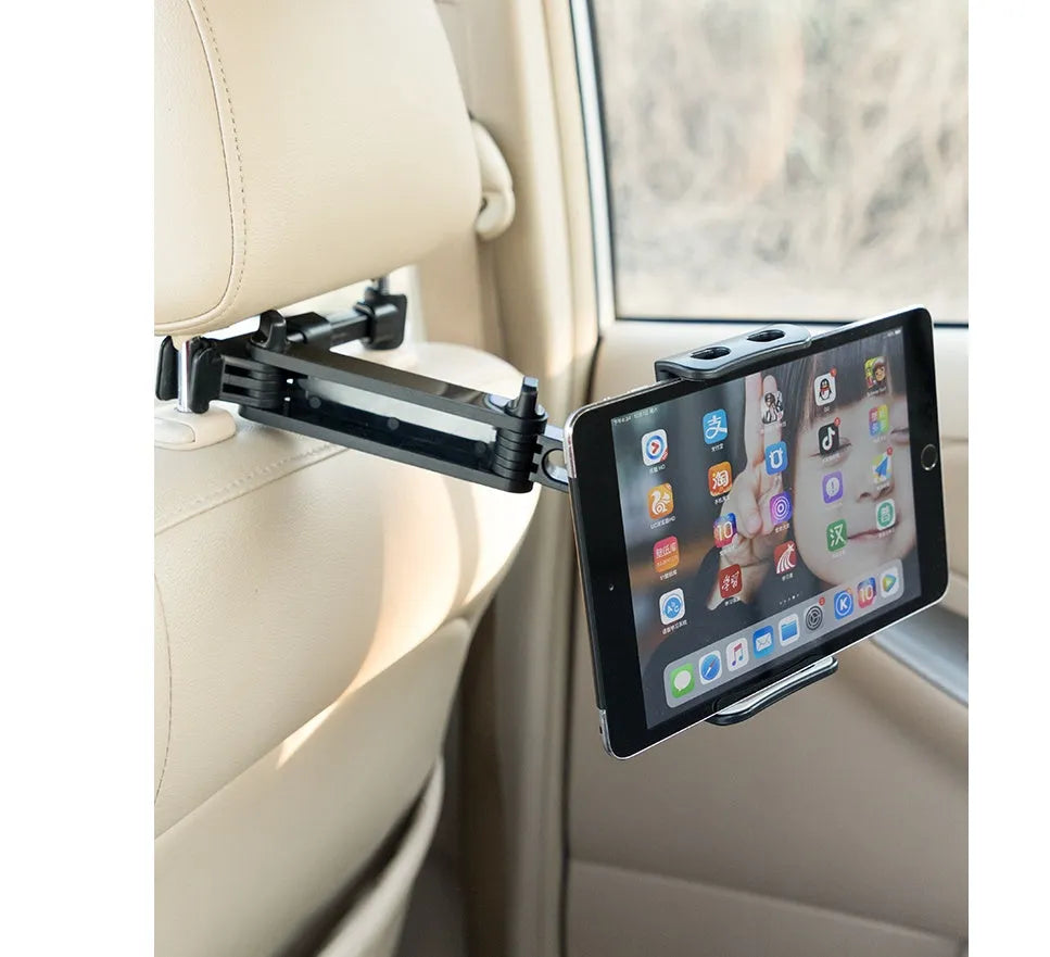 Black plastic car phone holder mounted on rear seat base holding a tablet for navigation