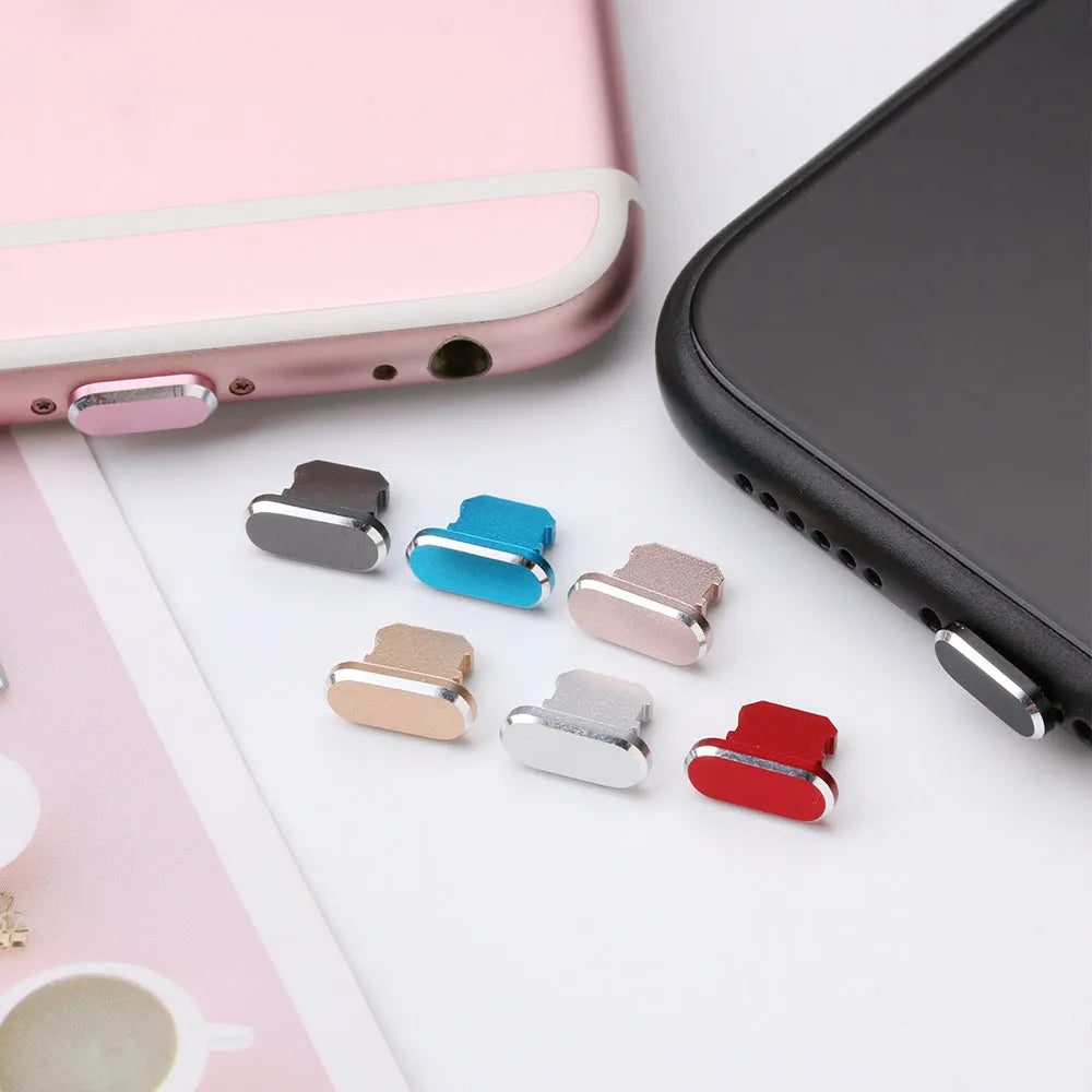 Aluminium alloy iPhone charging port dust plug in various colours on a white background.