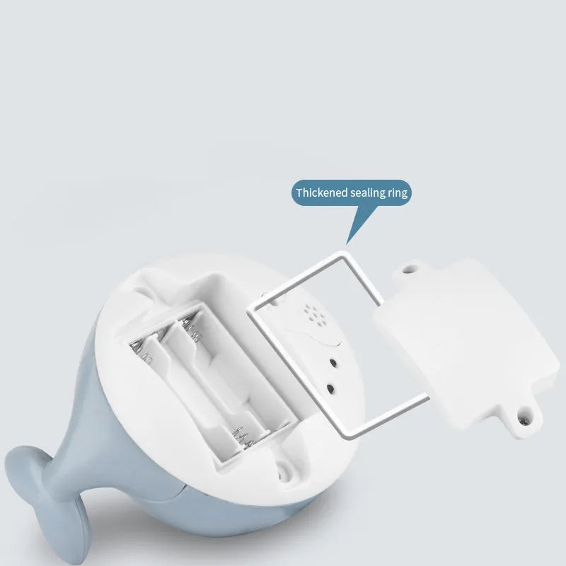 Electric whale-shaped bath toy with water spray, LED lights, and automatic water sensing for babies